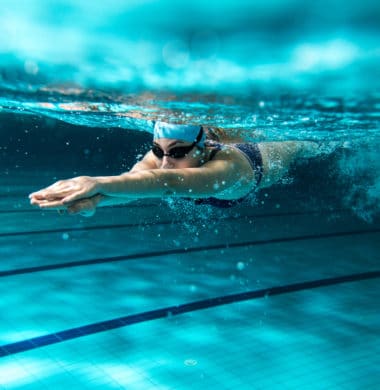 woman swimming laps to get cardiovascular exercise in the pool