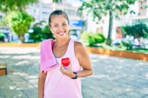 heart healthy woman holding a heart over her chest