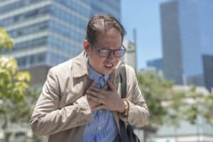 man clutching his chest during cardiac arrest