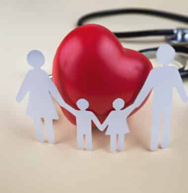 family surrounding a heart and a stethoscope