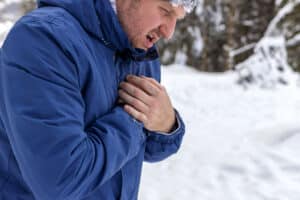 man experiencing a heart attack in cold weather