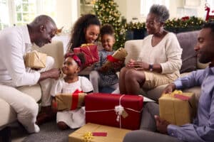 family opening holiday gifts together on the holidays