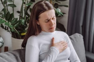 woman experiencing symptoms from a rapid heartbeat