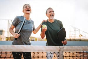 senior couple playing pickleball with a heart condition