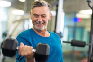 senior man lifting weights after a heart attack
