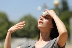 woman mopping her forehead on a hot day