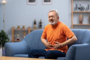 elderly man with heart disease having indigestion as a symptom
