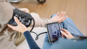 person checking their blood pressure as part of preventive cardiology care