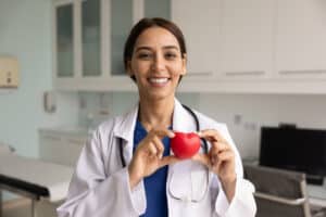 preventive cardiologist holding up a heart